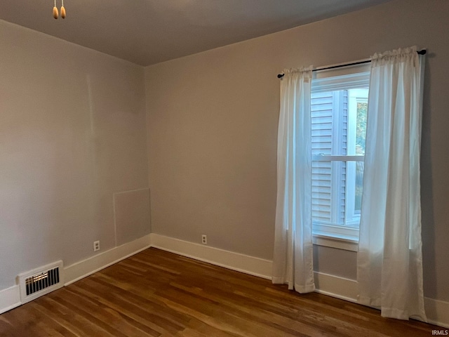 empty room featuring dark wood-type flooring