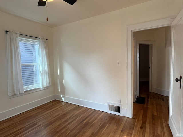 spare room with ceiling fan and dark hardwood / wood-style floors