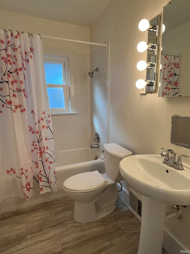 full bathroom featuring wood-type flooring, sink, toilet, and shower / tub combo with curtain