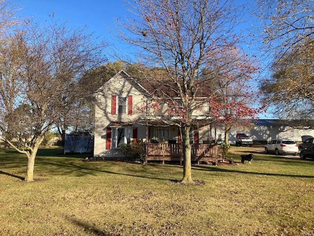 view of front of property with a wooden deck and a front yard