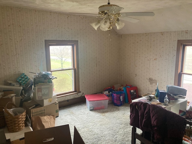 interior space featuring ceiling fan and carpet floors