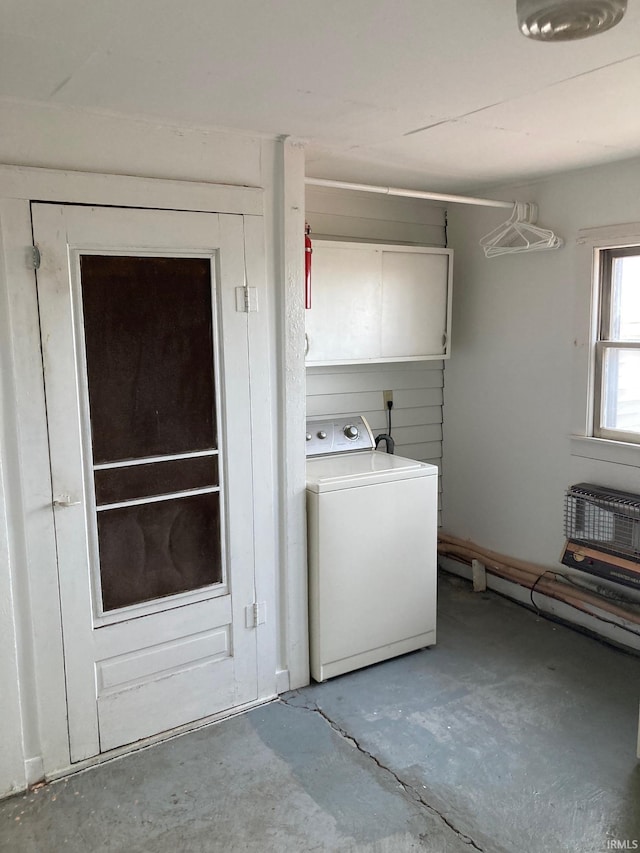 clothes washing area featuring cabinets, washer / dryer, and a wall unit AC