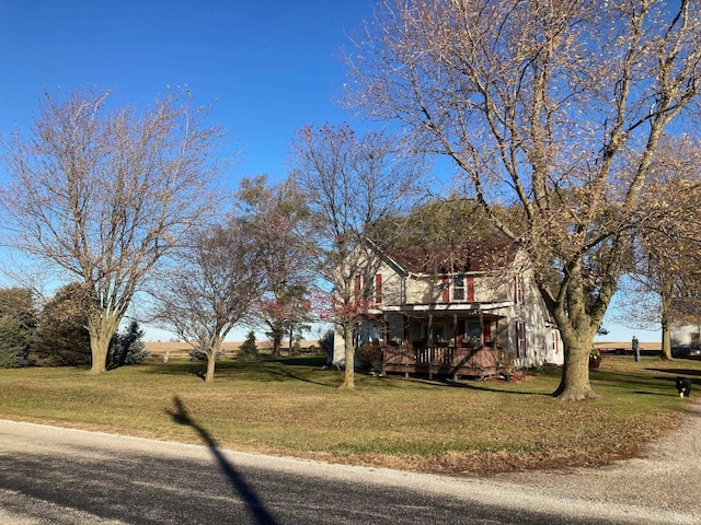 view of front of house featuring covered porch and a front lawn