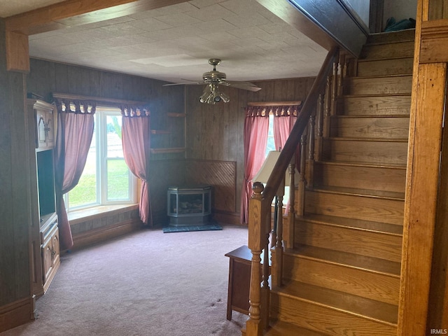 1139 E 600 N, Fowler, IN 47944 - stairs featuring wood walls, a wood stove, carpet flooring, and ceiling fan