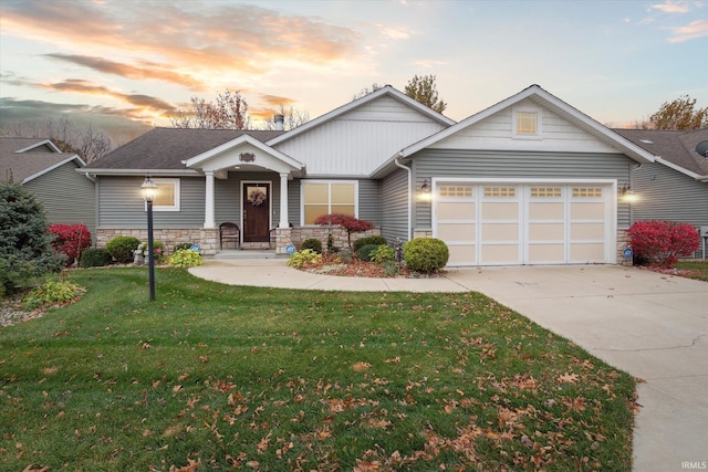 craftsman house with a garage and a lawn