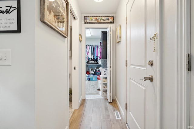 hallway with light hardwood / wood-style flooring