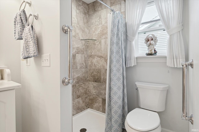 bathroom featuring toilet and a shower with shower curtain