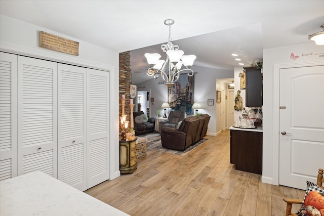 interior space featuring an inviting chandelier and light hardwood / wood-style flooring