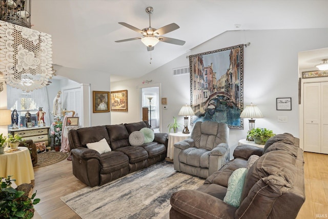 living room with light wood-type flooring, lofted ceiling, and ceiling fan