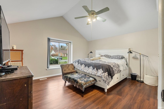 bedroom featuring dark wood-type flooring, vaulted ceiling, and ceiling fan