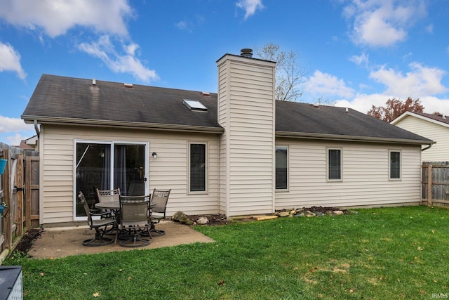 back of property featuring a patio area and a lawn