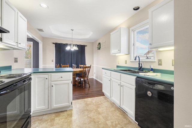 kitchen with hanging light fixtures, white cabinets, sink, and black appliances