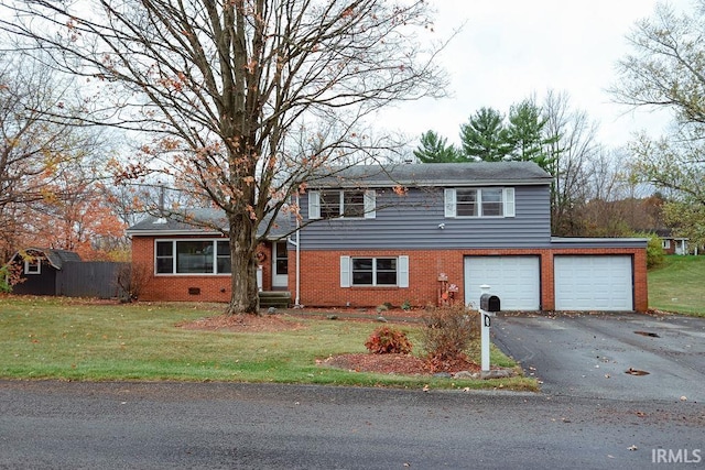 view of property featuring a garage and a front yard