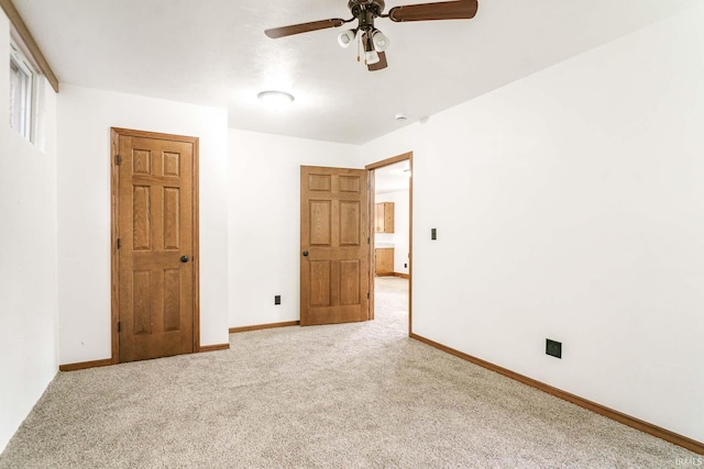 unfurnished bedroom featuring ceiling fan and carpet floors