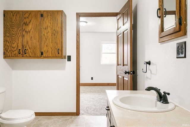 bathroom with tile patterned flooring, vanity, and toilet