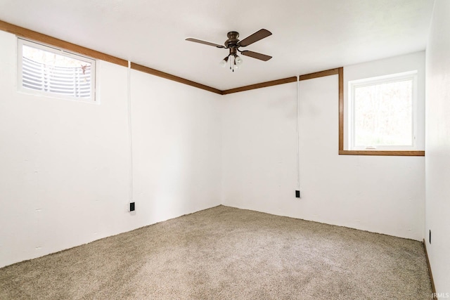 carpeted spare room featuring ceiling fan