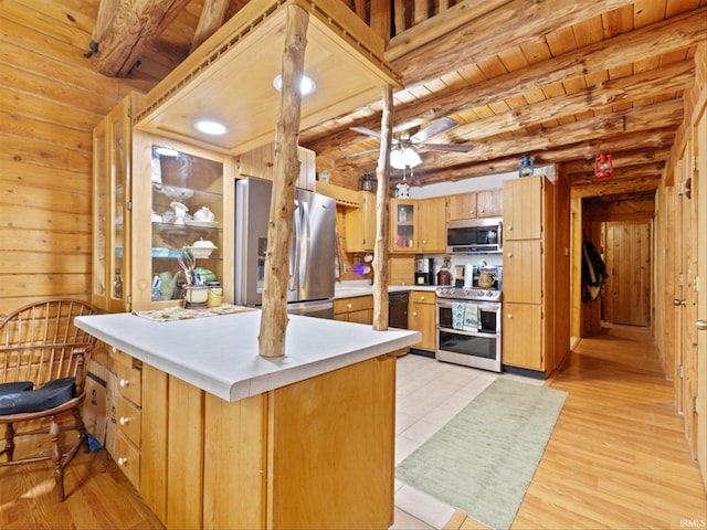 kitchen with beamed ceiling, appliances with stainless steel finishes, wooden ceiling, and light hardwood / wood-style flooring