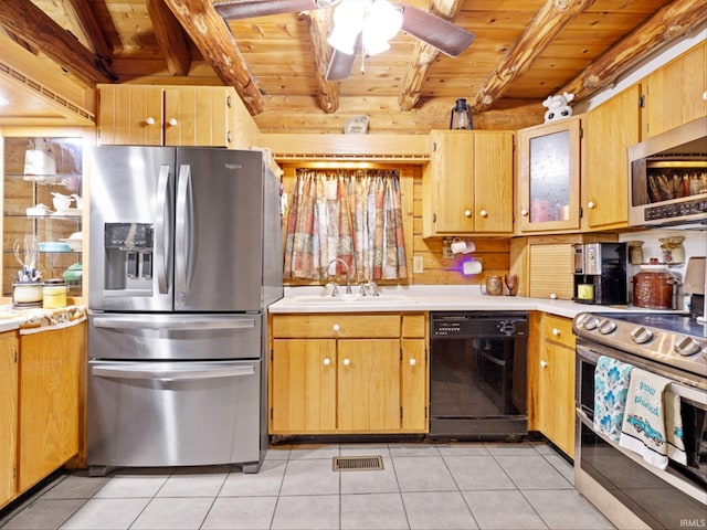 kitchen with beamed ceiling, appliances with stainless steel finishes, sink, and ceiling fan