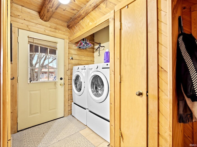 laundry room featuring separate washer and dryer, wooden walls, light tile patterned floors, and wood ceiling