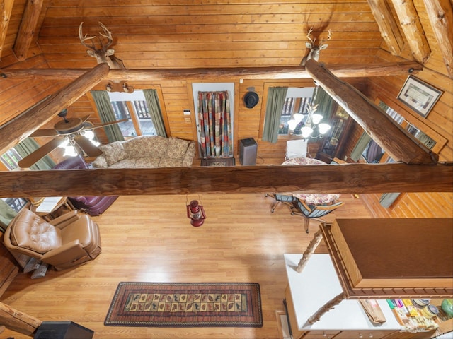 living room featuring wooden walls, hardwood / wood-style flooring, and ceiling fan