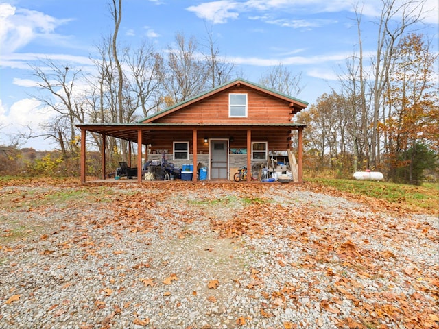 log-style house featuring covered porch