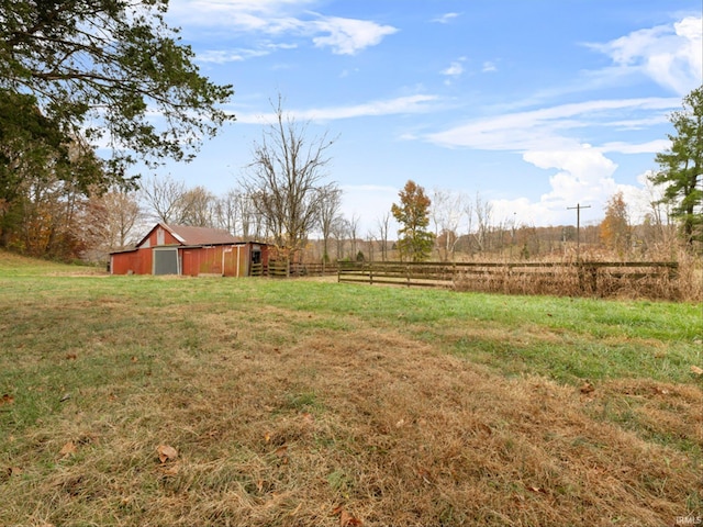 view of yard with an outdoor structure and a rural view