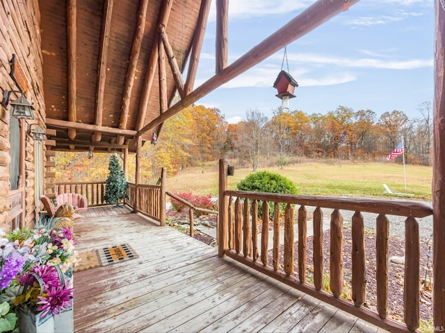 wooden terrace with a lawn