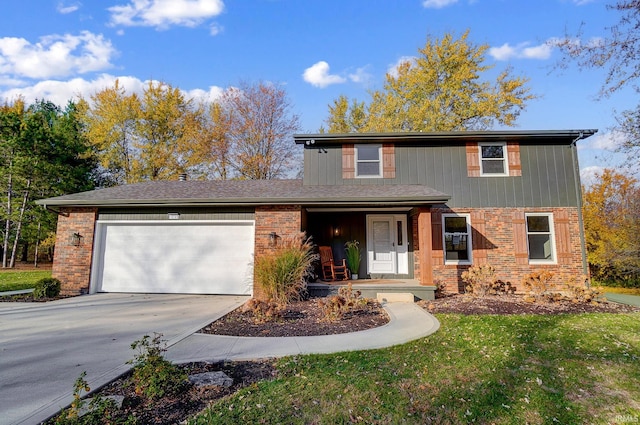 view of property with a front yard, a garage, and covered porch