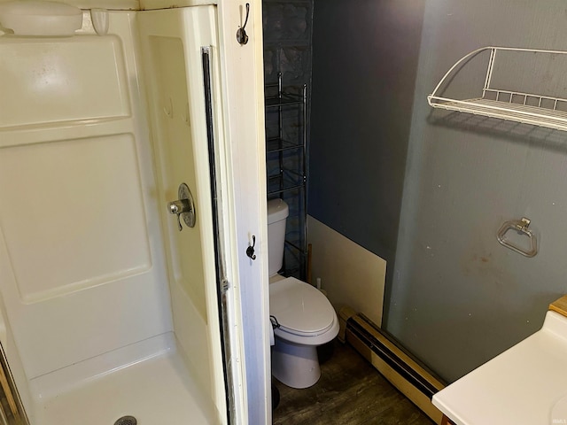 bathroom with wood-type flooring, toilet, baseboard heating, and a shower with shower door