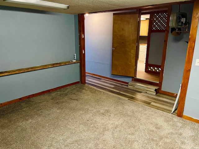 basement with carpet floors and a textured ceiling