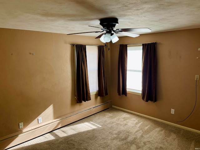 carpeted empty room with ceiling fan, a textured ceiling, and a baseboard radiator