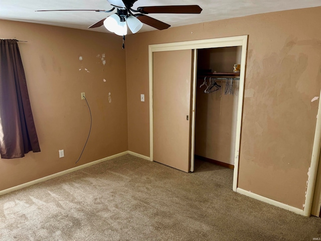 unfurnished bedroom featuring ceiling fan, a closet, and light colored carpet