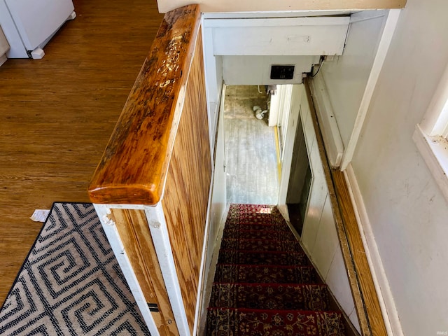 staircase with hardwood / wood-style flooring