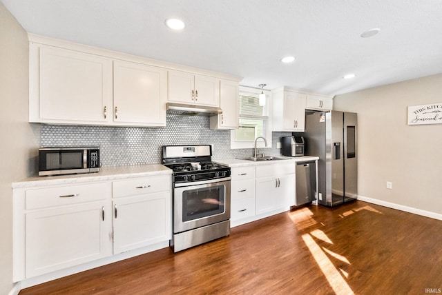 kitchen with dark wood-type flooring, white cabinetry, sink, and stainless steel appliances