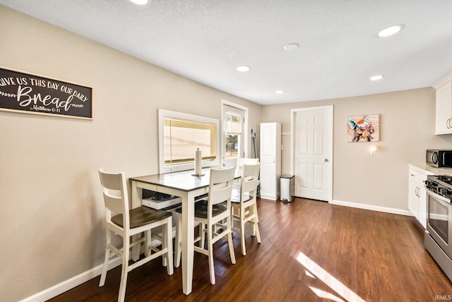 dining room with dark hardwood / wood-style flooring and a textured ceiling