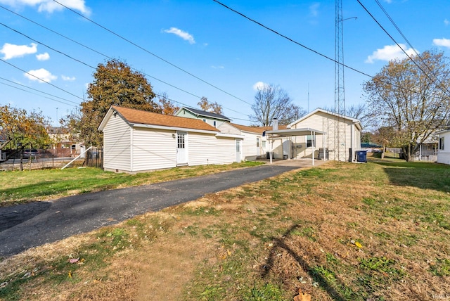 exterior space with a lawn and a carport