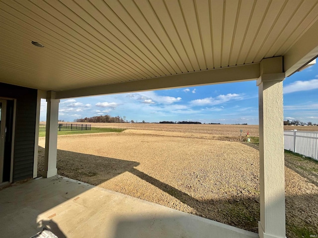 view of yard featuring a rural view and a patio