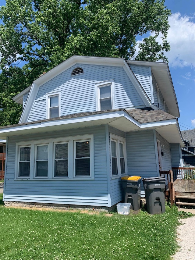 exterior space with a deck and a lawn