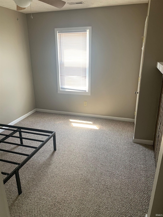 unfurnished room featuring light carpet and ceiling fan