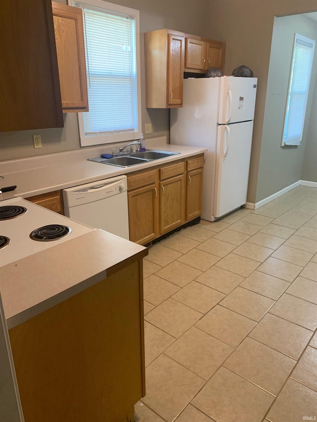 kitchen featuring sink, white appliances, and light tile patterned floors