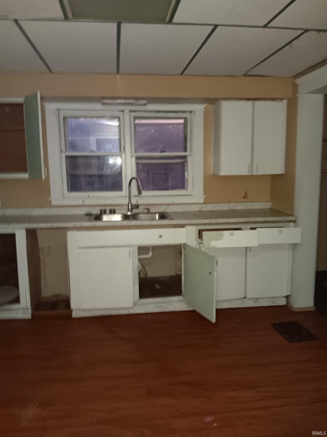 kitchen featuring white cabinets, a paneled ceiling, sink, and dark hardwood / wood-style floors