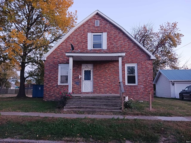 bungalow-style home with a front lawn