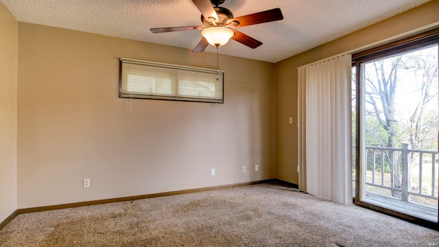 spare room featuring carpet flooring, a textured ceiling, and ceiling fan