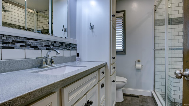 856 S Balthazar Dr, Santa Claus, IN 47579 - bathroom with toilet, a stall shower, vanity, wood finished floors, and baseboards