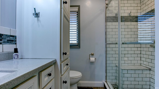 bathroom featuring walk in shower, vanity, and toilet