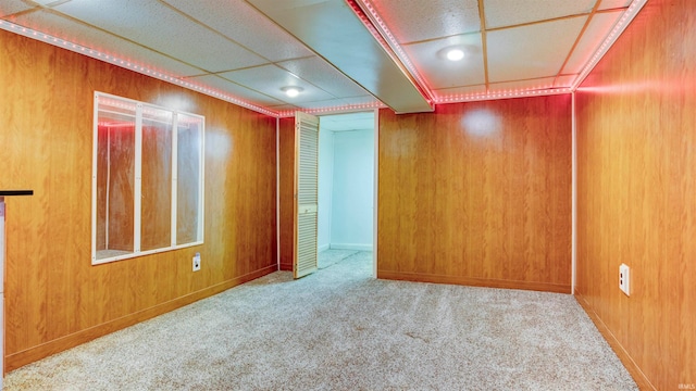 carpeted empty room with wooden walls