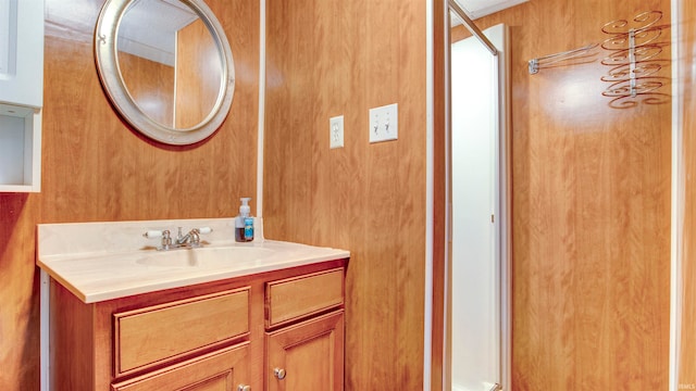 bathroom featuring vanity and wooden walls