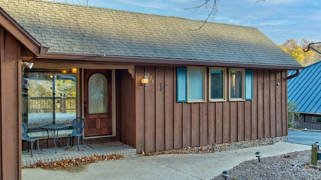 856 S Balthazar Dr, Santa Claus, IN 47579 - view of exterior entry with roof with shingles and board and batten siding