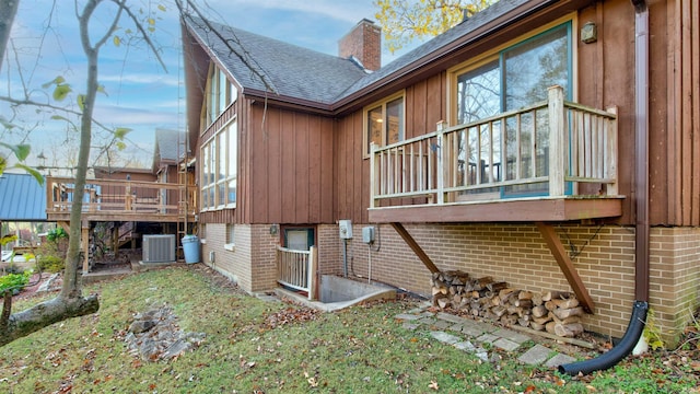 view of home's exterior featuring a deck and central AC unit