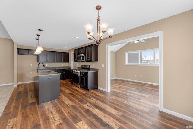 kitchen featuring appliances with stainless steel finishes, dark wood-type flooring, baseboards, a ceiling fan, and recessed lighting